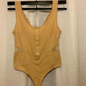 Cream bodysuit with lace cutout